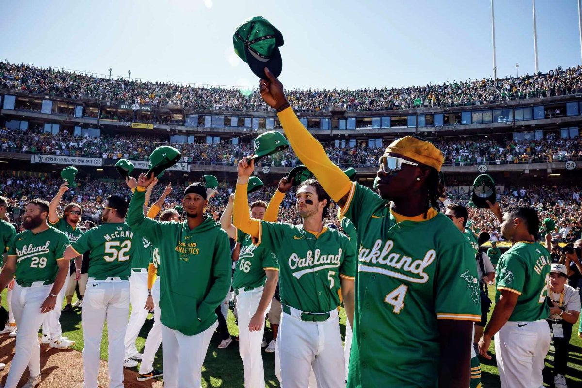 Lawrence Bulter and his team tip 
their hats to their fans after their final
game in Oakland. 