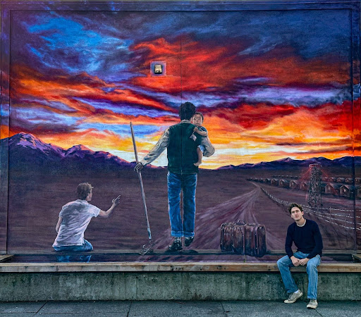 Analy graduate Owen Foley pictured in front of his newly-painted mural on the wall of the school library. Photo Credit: Lawson Gaylord.