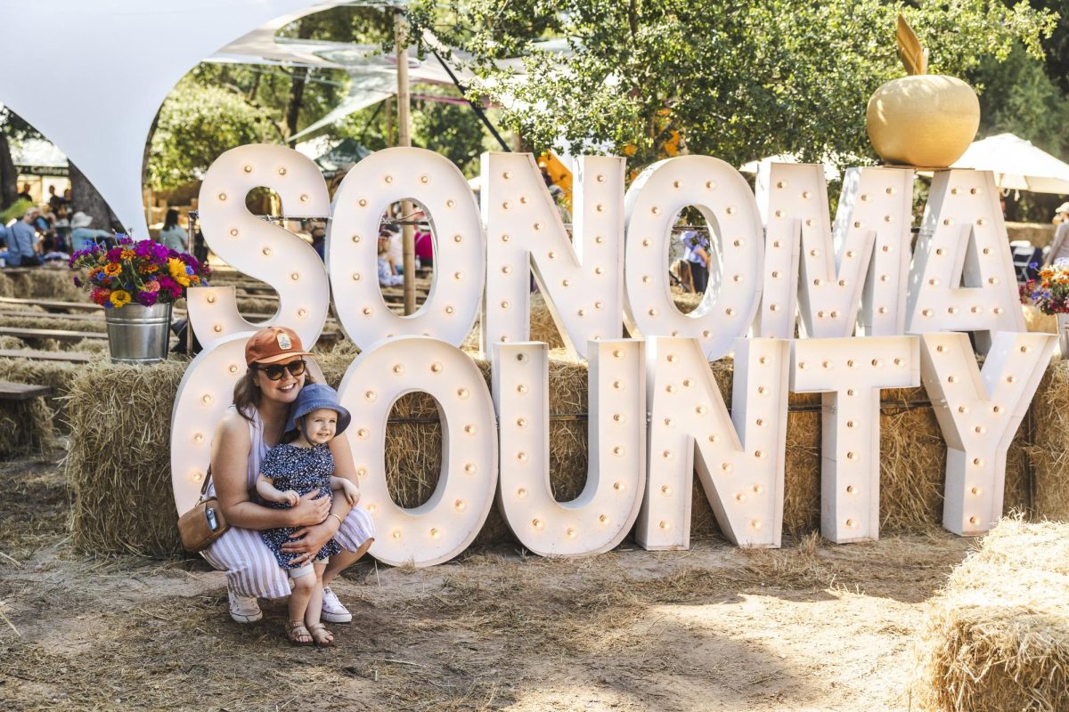 Fairgoers pose for a picture in front of the Sonoma County sign at the Gravenstein Apple Fair. Photo provided by the Sonoma County Farm Trails.